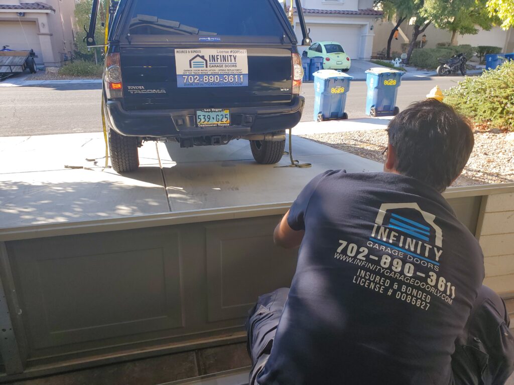 Infinity Garage Door technician diagnosing garage door problems in Las Vegas