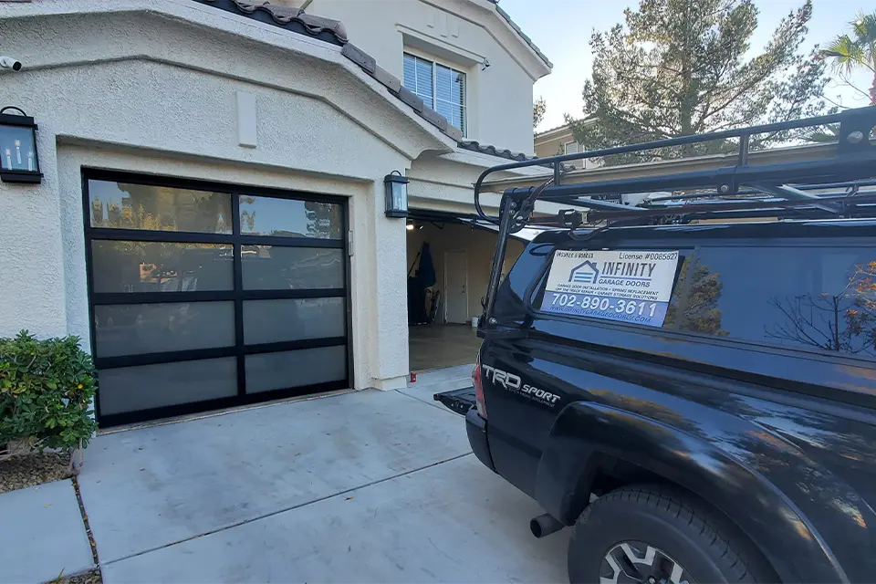 Coastal style garage door with a light color and open panel design.