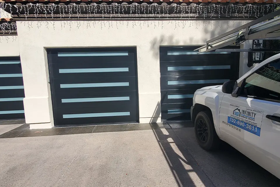 Contemporary garage door with mixed materials and geometric patterns.