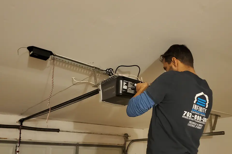 Technician repairing a garage door opener in North Las Vegas.