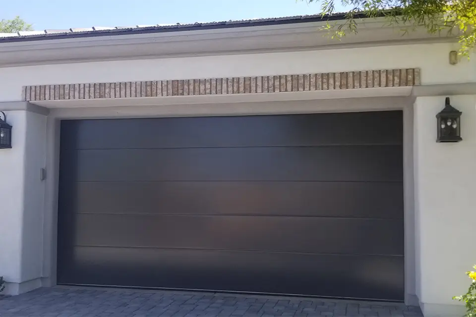 Modern minimalist garage door with flush panels and clean lines.