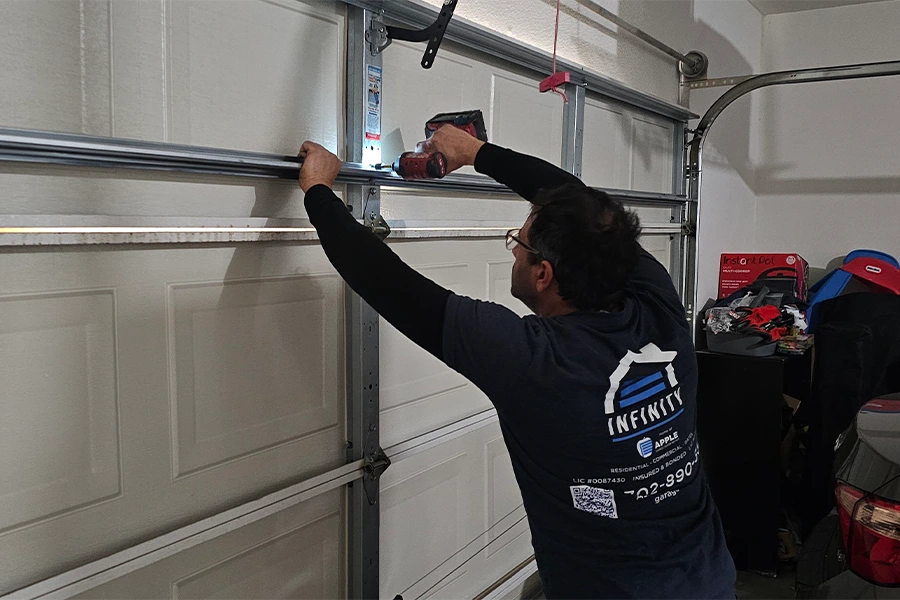 Skilled technician repairing a garage door panel in Las Vegas