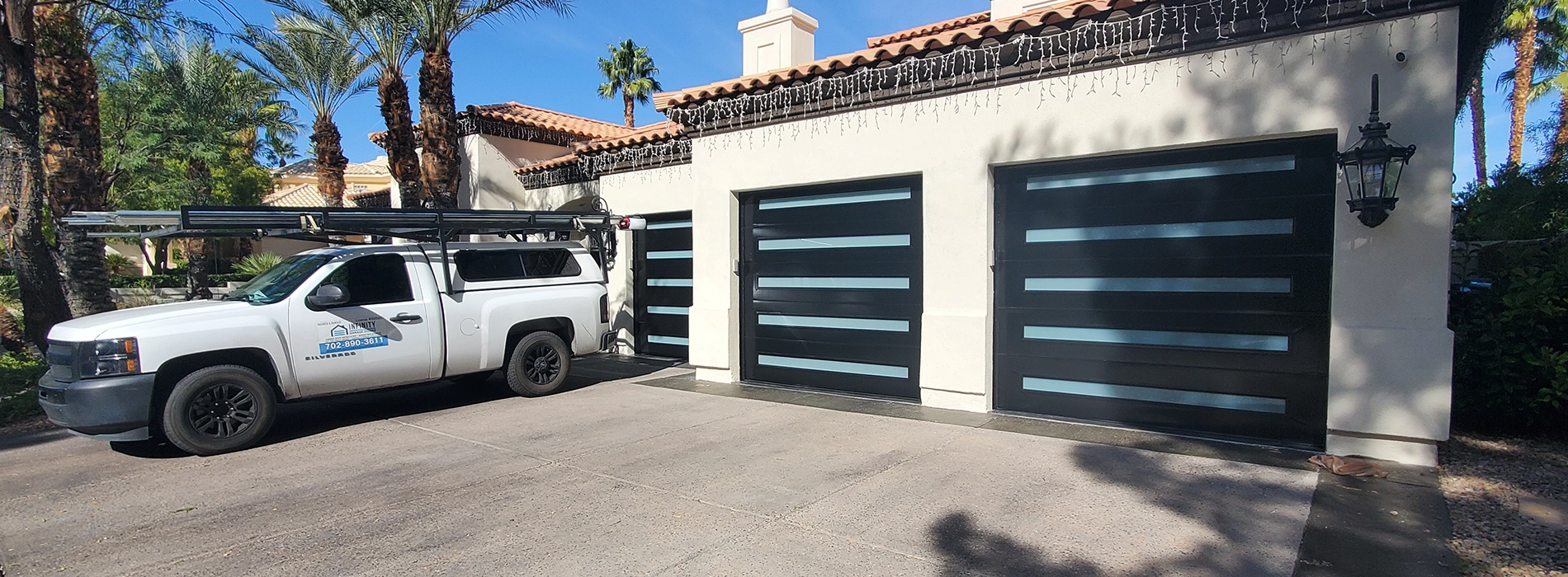 A modern garage door with clean lines and a minimalist design installed on a contemporary home in Las Vegas.